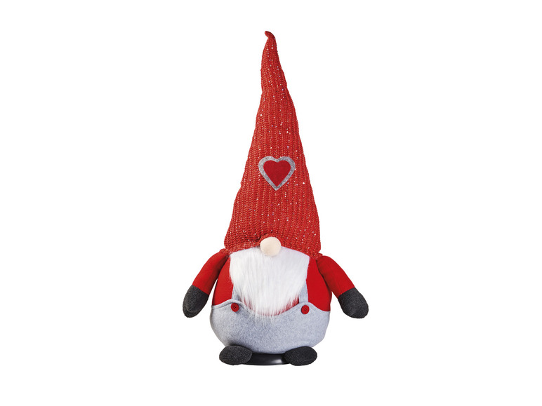 Ein roter Weihnachtswichtel mit einem Herz auf seiner Mütze.