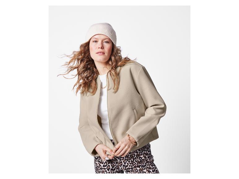 Frau in beiger Jacke und Wollmütze.