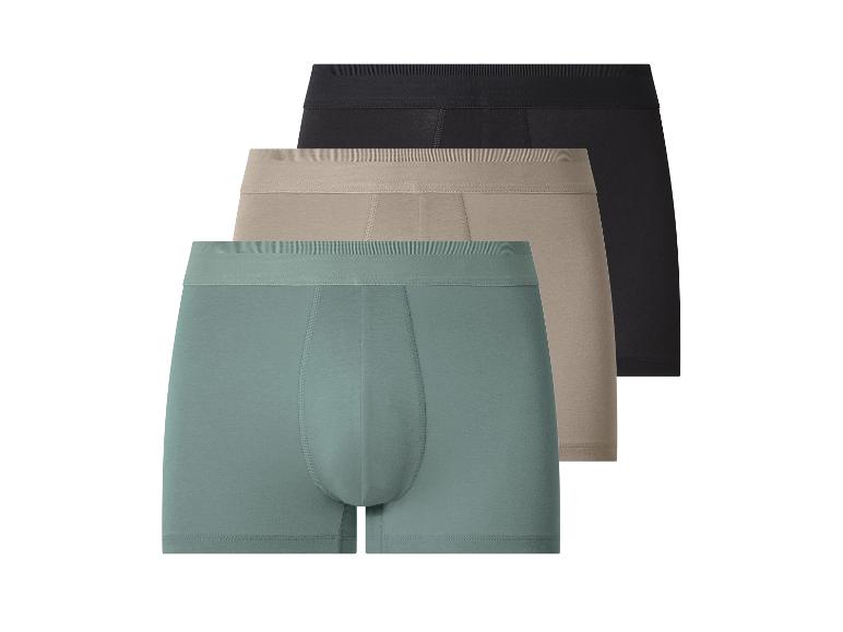 Set aus drei Herren-Boxershorts: schwarz, beige und türkis.