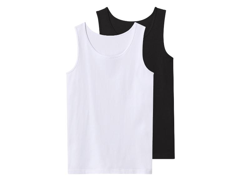 Zwei Tanktops, ein weißes und ein schwarzes, flach liegend.