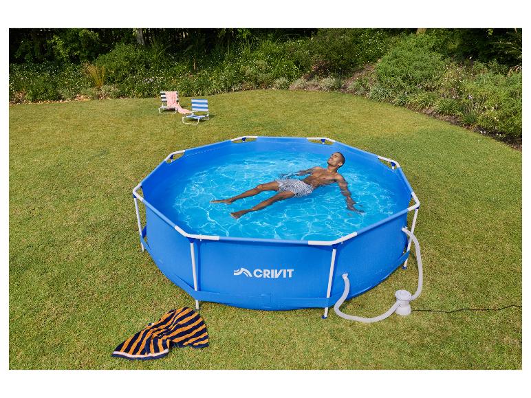 Mann entspannt sich in einem blauen sechseckigen Aufstellpool im Garten mit zwei Liegestühlen.