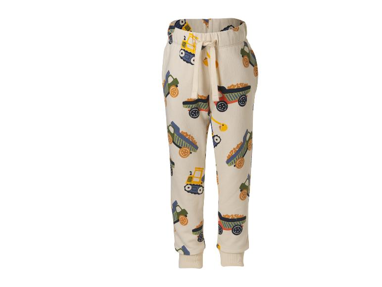 Beige Kinder-Jogginghose mit Baustellenfahrzeug-Print.