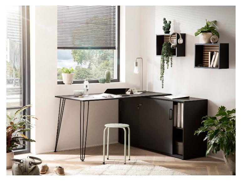 Schwarzer L-förmiger Schreibtisch mit Stauraum, hellgrüner Hocker und Pflanzen in einem hellen Home-Office.