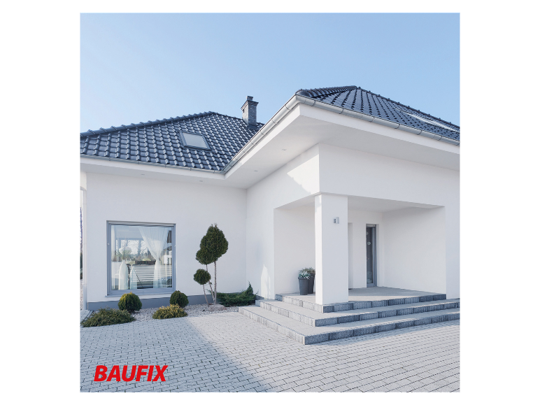 Modernes Haus mit Dachziegeln, Pflaster und Garten.