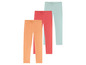 Drei Paar Leggings in Orange, Rosa und Mintgrün.