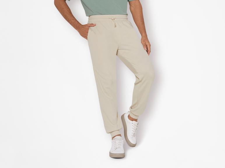 Beige Jogginghose und weiße Sneaker: lässiger Look.