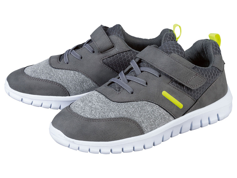 Zwei graue Turnschuhe mit Klettverschluss.