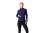Frau in dunkelblauer Sportjacke und schwarzer Leggings hält eine Trinkflasche