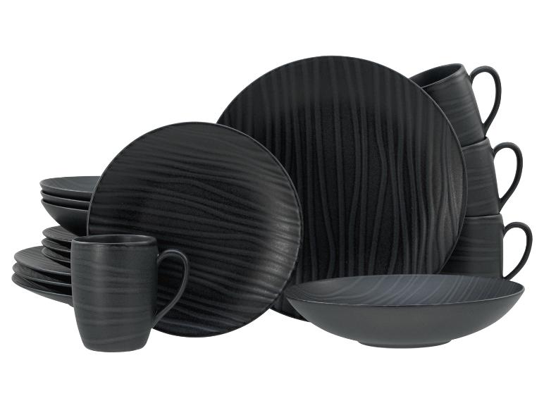 Schwarzes Steingut-Geschirrset mit Tellern, Schalen und Tassen im Wellendesign.