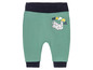 Grüne Babyhose mit Kaninchen- und 'Happy'-Druck.