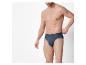 Mann in dunkelblauer Unterhose, der am Bund festhält.