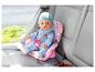 Baby Born Puppe in einem rosa Puppenautositz