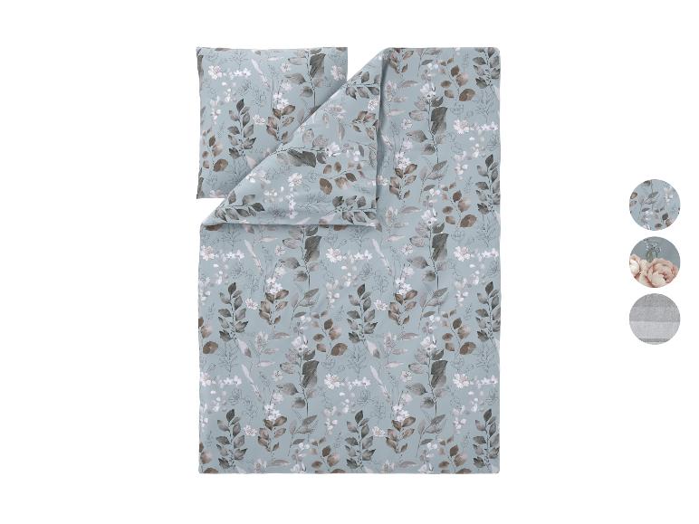 Bettwäsche-Set mit blauem Hintergrund und braunen und weißen Blatt- und Blumenmustern.