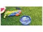 Wasserpistole, Strandball, Sonnenbrille und Eimer Wasser auf dem Gras.