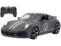 Graues ferngesteuertes Spielzeugauto mit leuchtenden Scheinwerfern und Fernbedienung.