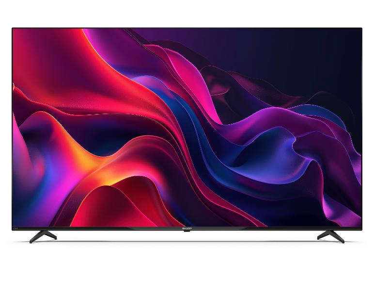 Fernseher mit farbenfrohem abstraktem Bildschirmhintergrund, stehend auf einer weißen Oberfläche.