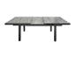 Ausziehbarer grauer Tisch mit Holzoptik und schwarzen Beinen.