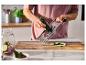 Eine Person reibt eine Zucchini mit der SILVERCREST® Edelstahlmultireibe.