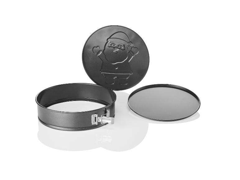 Eine Springform mit Santa Claus Design, einem herausnehmbaren Boden und einem Backblech.