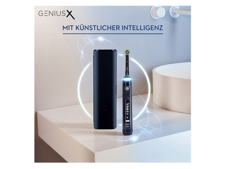 Eine Oral-B Genius X elektrische Zahnbürste und eine Ladestation auf einem Badezimmerwaschbecken.
