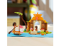 Spielzeugset mit Figuren, Boot, Palme und Gebäude auf blauem Untergrund.