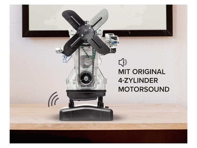 Transparentes Motormodell mit Lüfter auf einem Holztisch, mit deutschem Text.