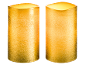 Zwei strukturierte goldene LED-Kerzen, leuchtend mit warmem Schein.