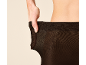 Frau passt schwarze Strumpfhose an der Taille an