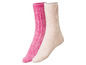 Zwei Paar weiche Wollsocken in Rosa und Beige.