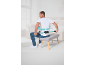 Sitzender Mann bei der Anwendung eines Rückenmassagegeräts.