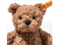 Flauschiger brauner Teddybär mit einem gelben Schildchen im Ohr.