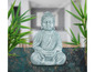 Eine graue Buddha-Figur in Meditationshaltung.