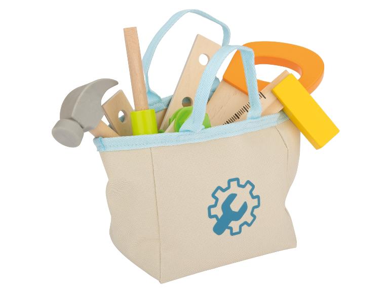 Eine Stofftasche mit Werkzeug, darunter ein Hammer und ein Lineal.