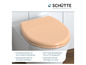 Ein beigefarbener Toilettensitz von Schütte mit Soft-Close-Funktion.