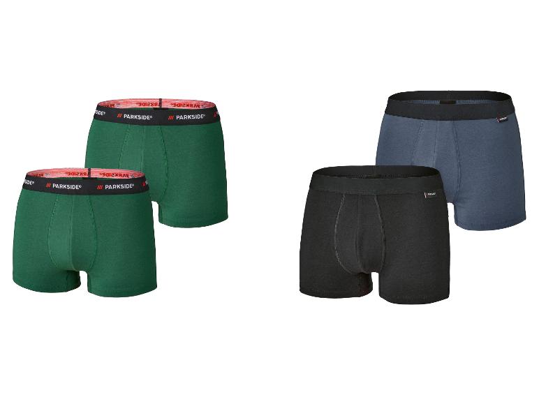 Vier Parkside Boxershorts: zwei grüne mit rotem Bund, eine schwarze und eine blaue mit schwarzen Bünden.