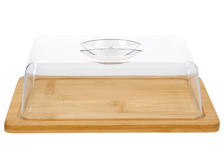 Holzbrett mit transparenter Kunststoffhaube für Käse oder Butter.