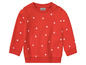 Ein roter Pullover mit weißen Punkten von Impidimpi.