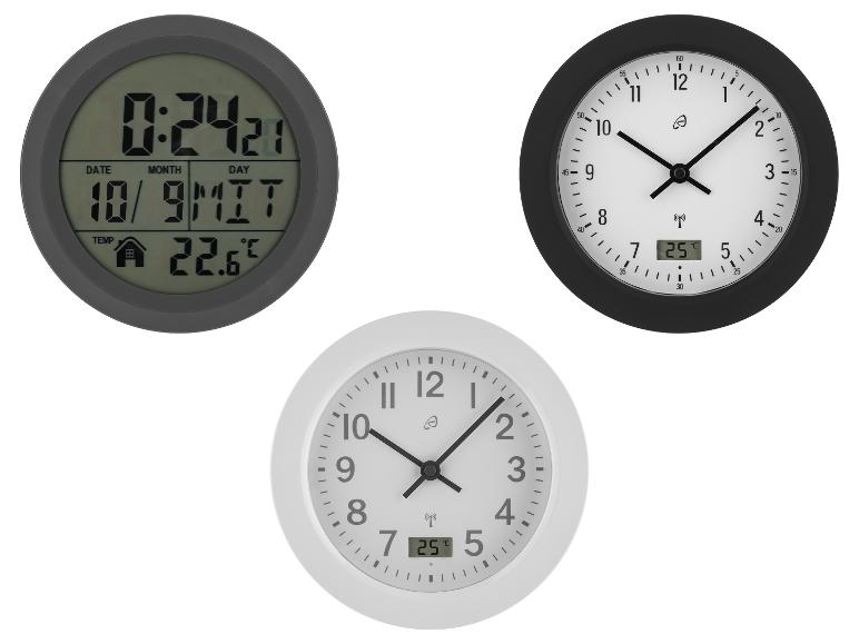 Drei Wanduhren: eine digitale und zwei analoge, die Uhrzeit und Temperatur anzeigen.