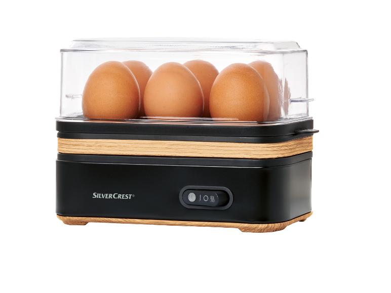 SilverCrest Eierkocher: Eier in einem Gerät aus Holz und Schwarz.