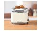 Beiger Retro-Toaster mit Brötchen auf dem Rost, auf einer Holztheke.