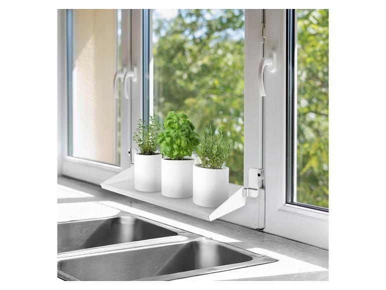 Weißes Fensterregal mit drei Topfkräutern (Thymian, Basilikum, Rosmarin) über einer Küchenspüle.