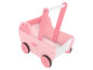 Ein rosa hölzerner Puppenwagen mit Herzen.