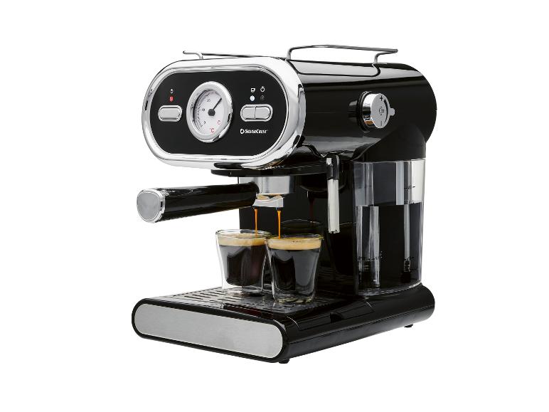 Schwarze Espressomaschine mit Chromdetails, die zwei Kaffees in Gläser zubereitet.