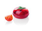 Eine rote, tomatenförmige Aufbewahrungsbox mit einer halben Tomate daneben.