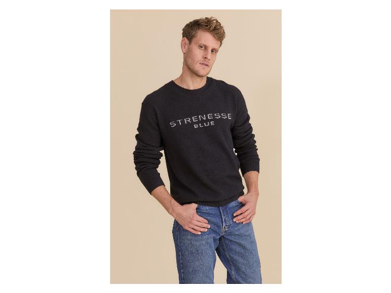 Mann in schwarzem Strenesse Blue Pullover und blauen Jeans.