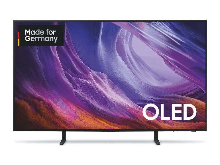 Ein Fernseher mit einem lebendigen lila-orangen abstrakten Display, mit den Texten „Made for Germany“ und „OLED“.
