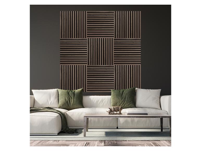 Wohnzimmer mit weißem Sofa, grünen Kissen und einer Wanddekoration aus Holzlamellen.