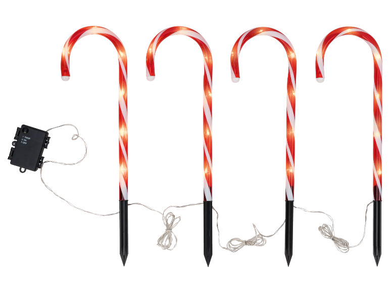 Vier beleuchtete Zuckerstangen-Wegeleuchten mit roten und weißen Streifen, verbunden mit einer Steuerbox.