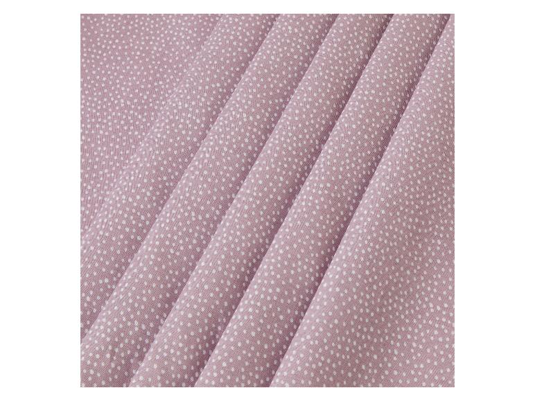 Rosa Stoff mit weißen Punkten.