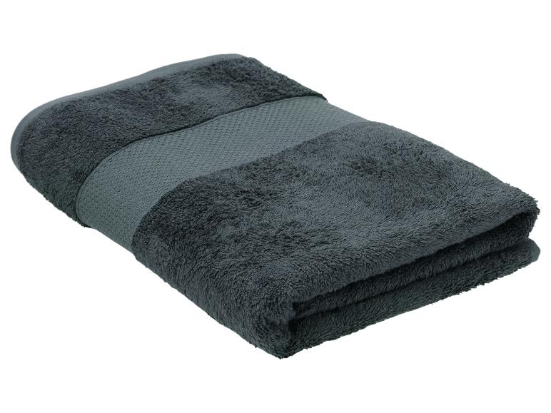 Gefaltetes dunkelgraues Handtuch mit strukturiertem Band